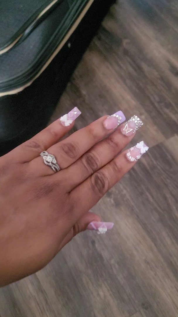 Manicured nails displayed in a salon setting.